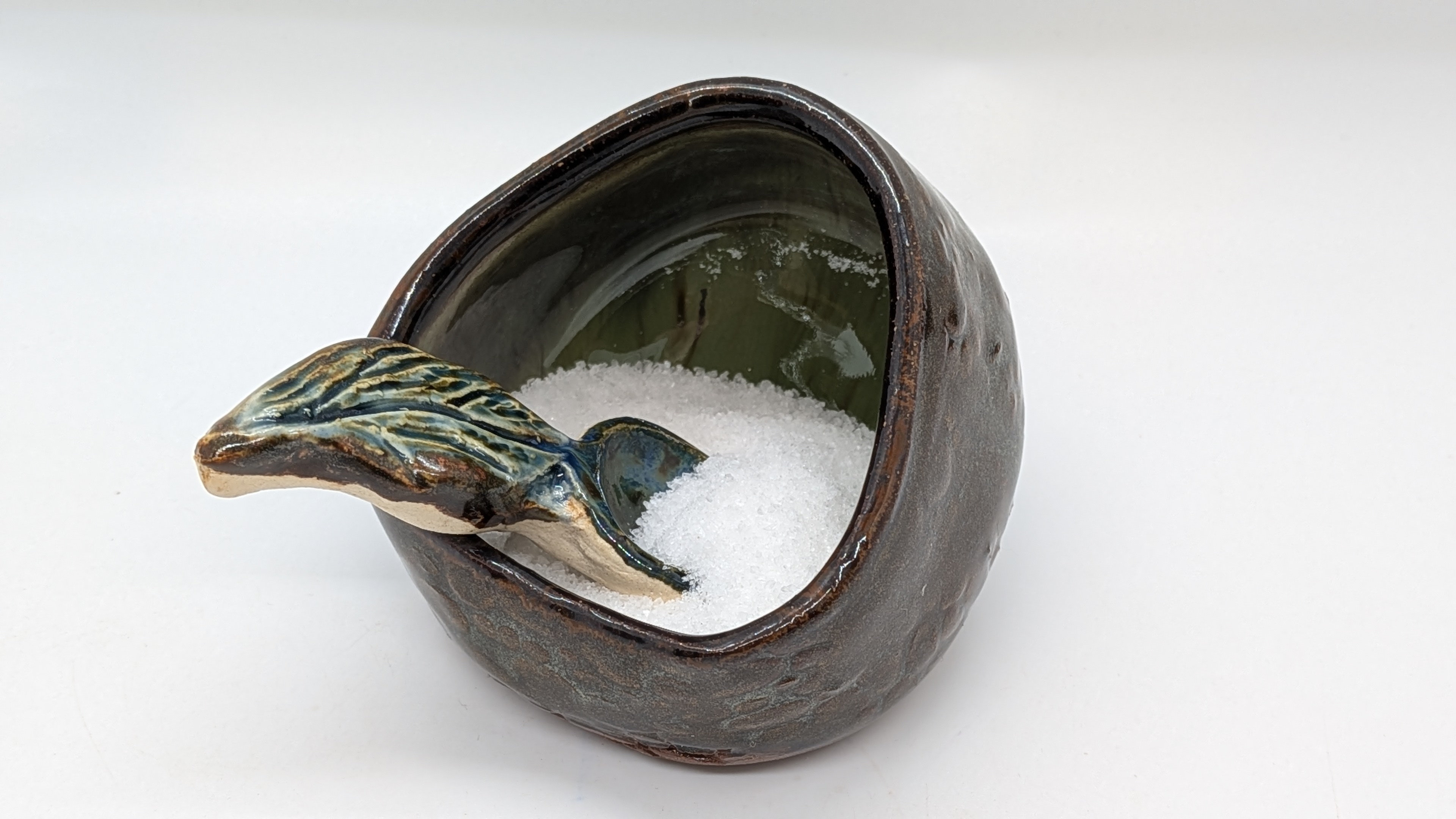 Green Earth Open-Mouth Salt Cellar - This cellar sits at an angle to open to the front. A great complement to some of my smaller scoops, and making sugar, salt, or other favorite spices easy to reach at all times.

This one has an earthy green interior with a warm, brownish-gray exterior and cobblestone texture - adding a touch of nature to your kitchen decor. And it pairs beautifully with my other items featuring shades of green.

Sugar and Spice Scoop sold separately. - 15