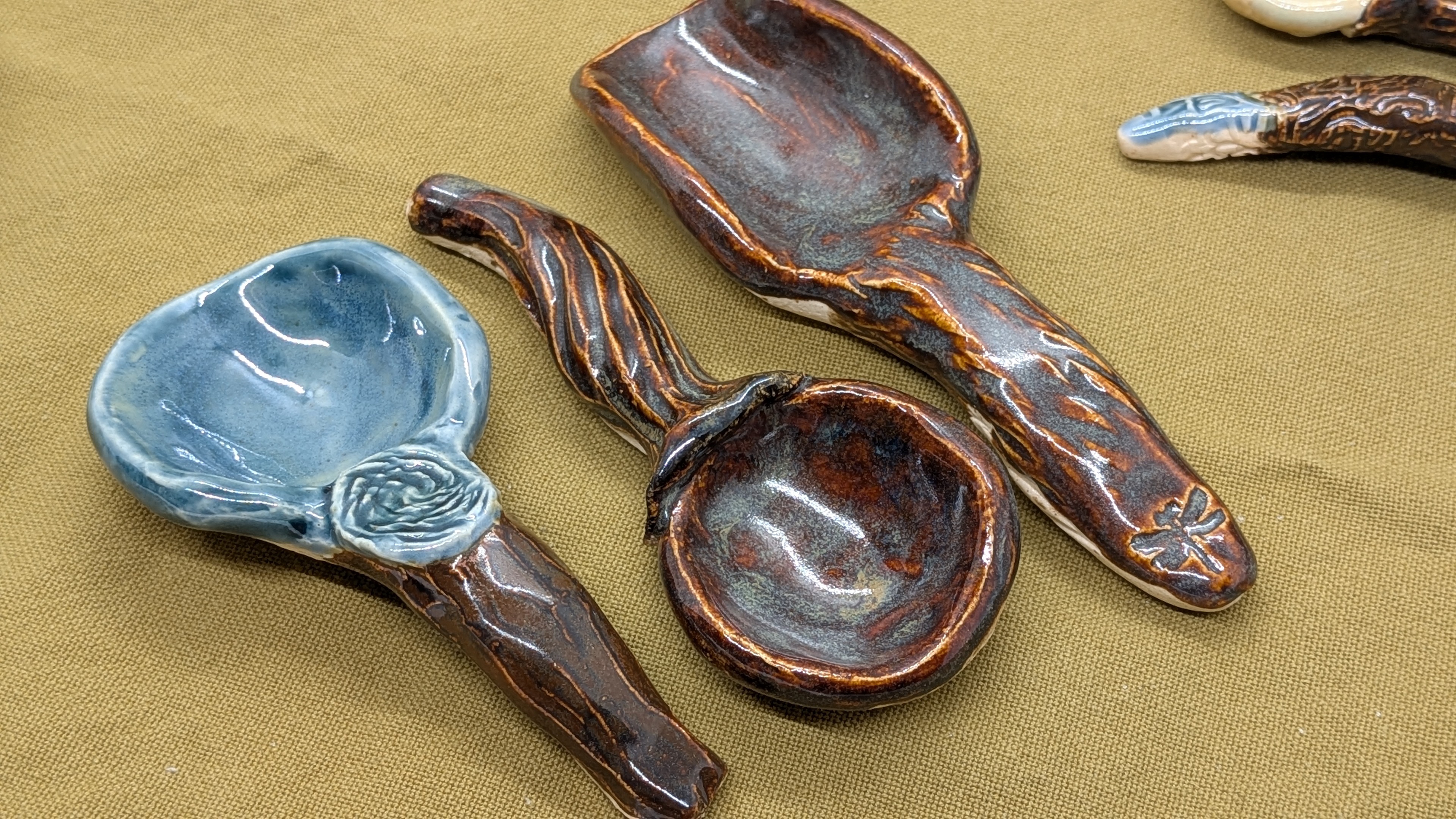  - Each of these little scoops was hand-formed, then carved and/or textured. They are all glazed on top surfaces, with mostly bare clay on the bottom for safe firing in the kiln. 

Like my other work, they're dishwasher-safe, however, I suggest handwashing to protect them from larger, heavier items in your dishwasher. 